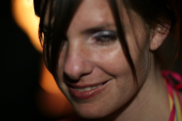 Candid Close-Up Portrait of Smiling Woman at Night