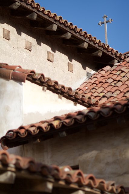 A Cross on a Traditional Tile Roof