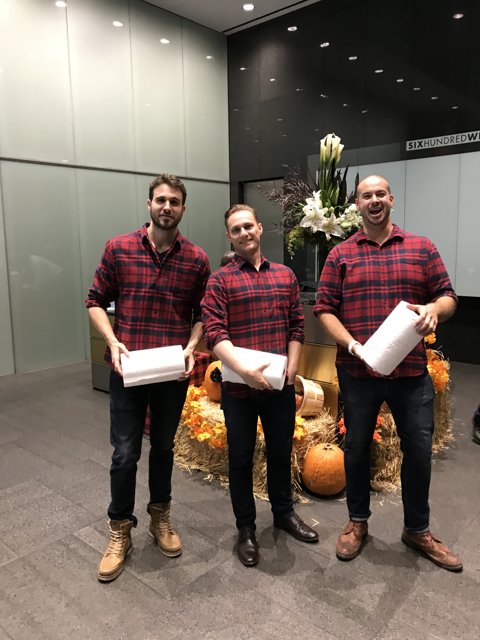 Three Men with Boxes and a Flower Arrangement