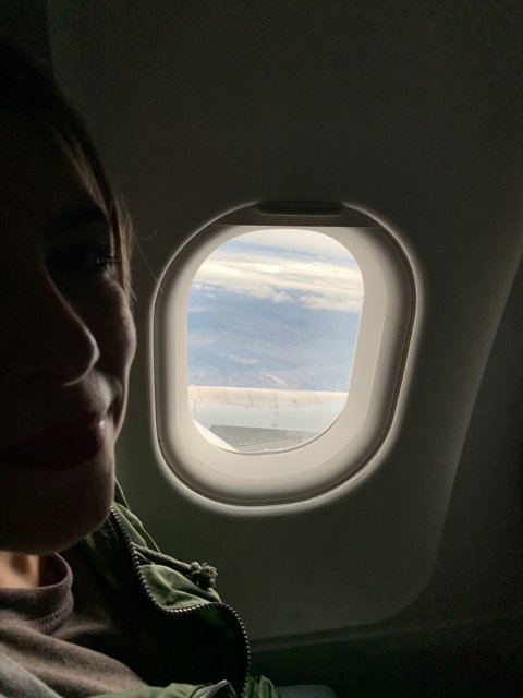 A Woman's Plane Window View