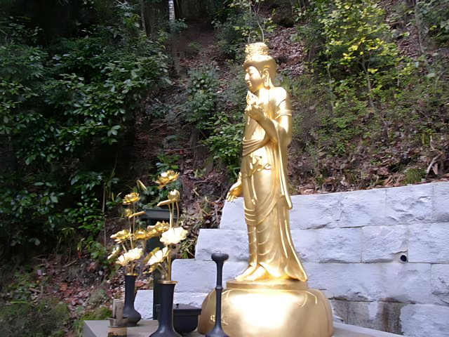 Golden Buddha Statue amidst the Kyoto Hills