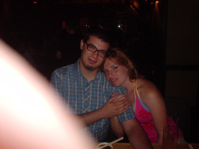 Couple Sharing a Close Moment at Dimly Lit Restaurant
