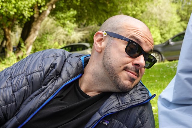 Man with Daisy on Sunglasses in Park