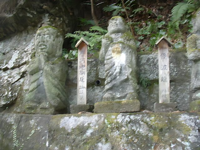 Statues of Buddhas on a Rock Wall