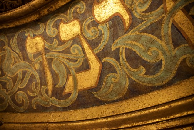Golden Arabic Writing on a Historical Building