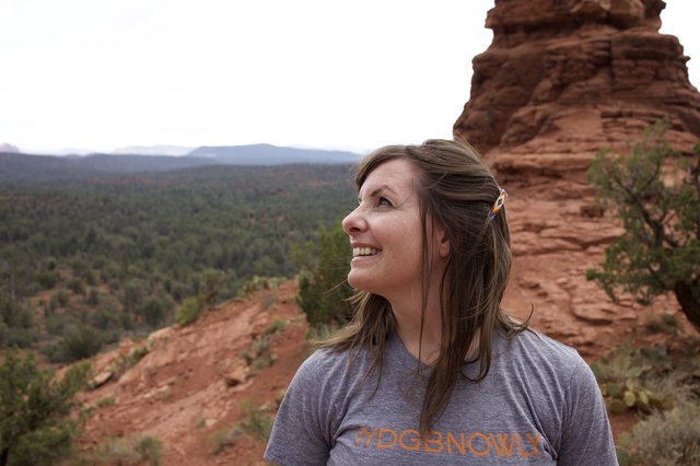 Woman Gazing Upward at Sedona Red Rock Formation