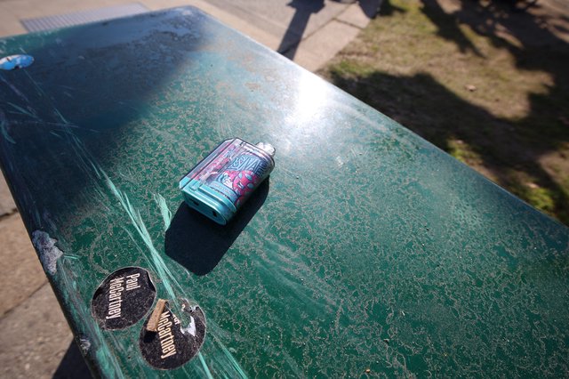 Crushed Beer Can on Worn Green Ping Pong Table