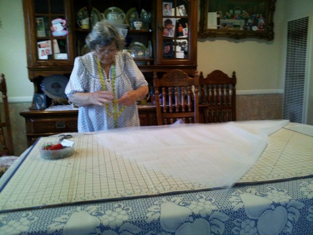 The Art of Linen: A Woman Cuts a Tablecloth
