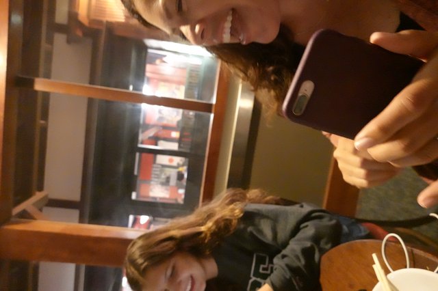 Friends Sharing a Moment on Their Phones