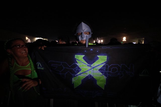 Masked DJ Peeks Over Exxion Banner at Wobbleland