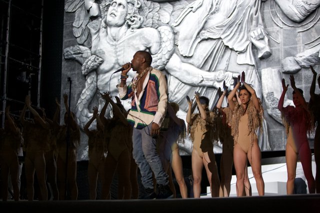 Stage Performance with Dancers and Microphone