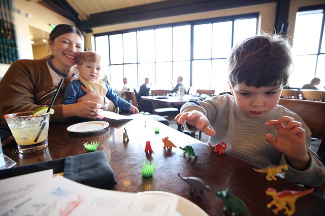 Family Mealtime with Dinosaur Play at Restaurant