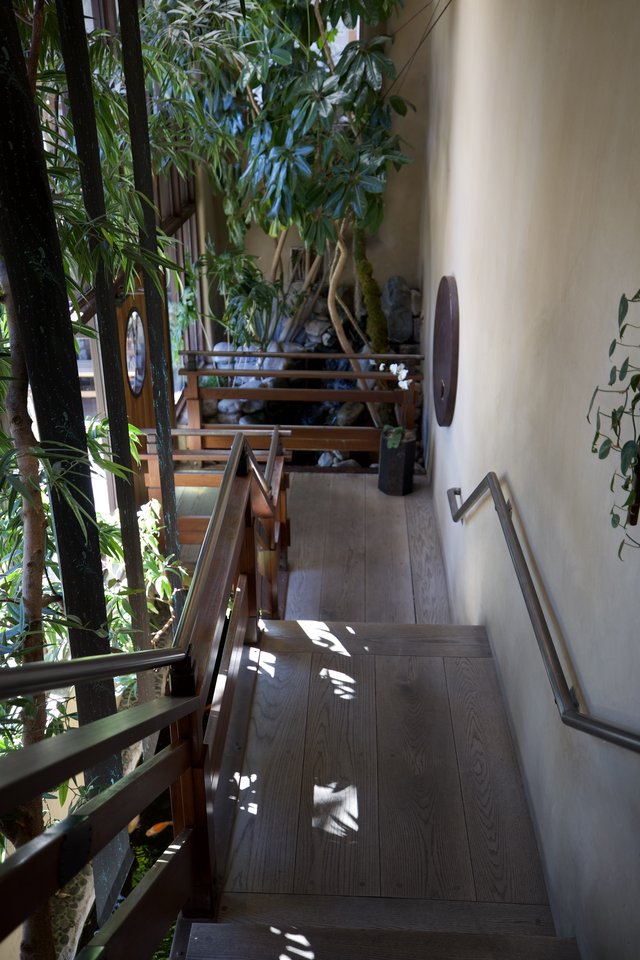 Serene Japanese-Inspired Indoor Garden Staircase with Natural Light