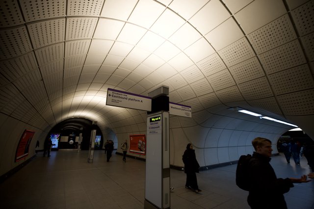 Underground Station Platform Directional Signage at Rush Hour