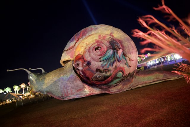 Colorful Snail Statue Lights Up Coachella Night Sky