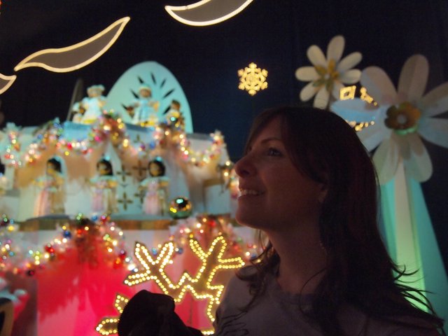 Woman Enjoying It's a Small World Holiday Display