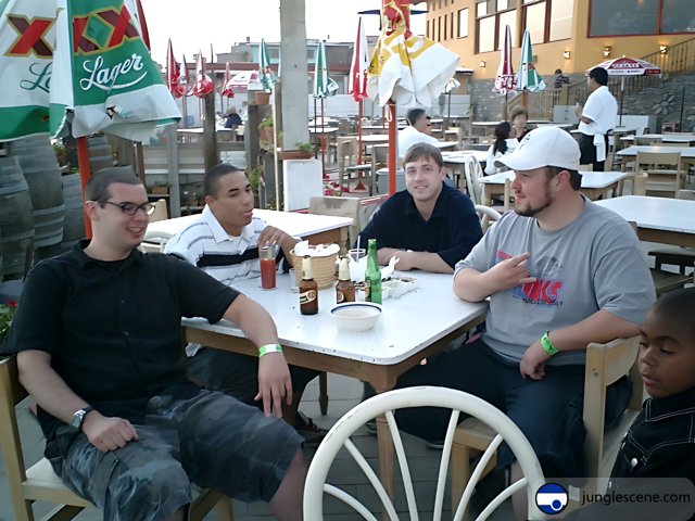 Four Men Enjoying Beer and Food at a Restaurant