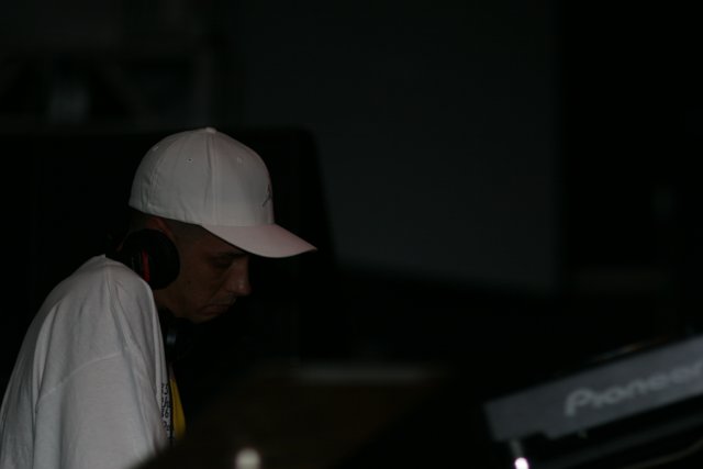 DJ S in His White Baseball Cap and Headphones