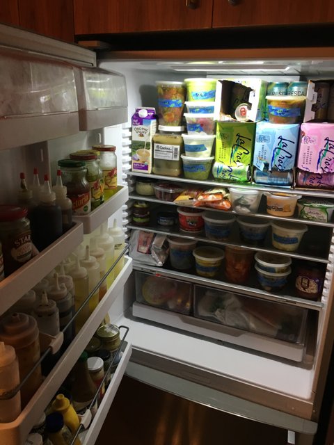 Refrigerator stocked with fresh groceries