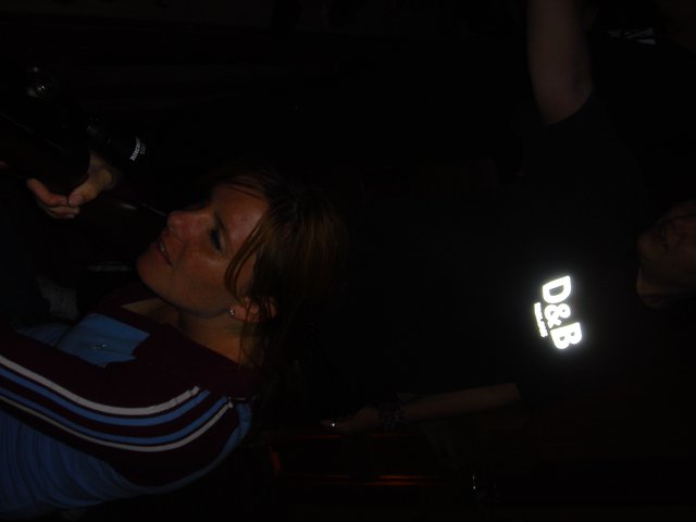 Woman Laughing in Dark Nightclub Setting