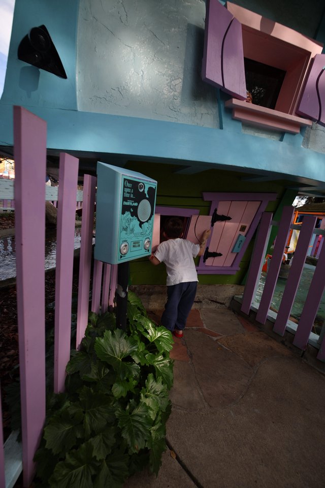 Child Exploring Interactive Installation at Whimsical Waterside Pavilion