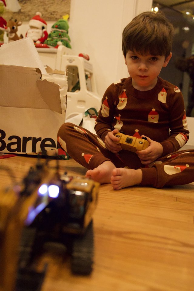 Young Boy Playing with Remote Control Toy on Christmas Morning