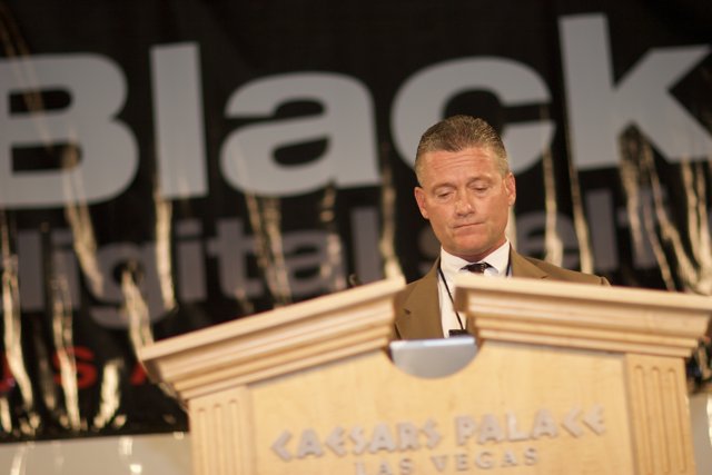 A Man in a Suit and Tie Addressing a Crowd