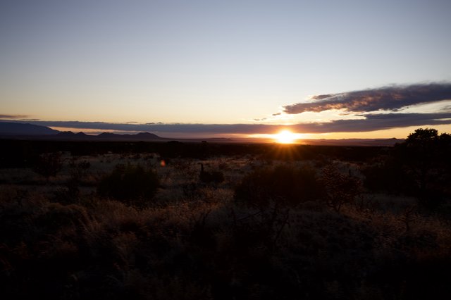 Desert Sunset Over Distant Mountain Ranges