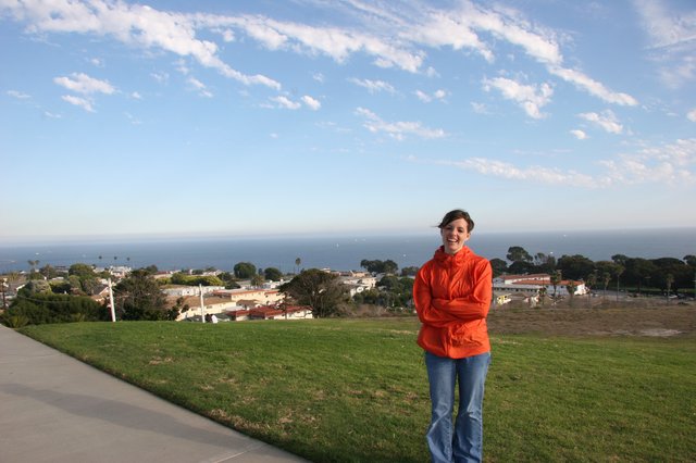 Woman in Orange Jacket Overlooking Coastal California Town
