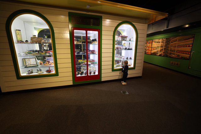 Young Visitor Explores Vintage Toy Display at Museum