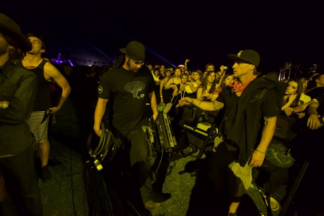 Band Member and Hat-Wearing Man at Coachella Concert
