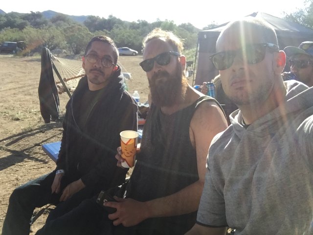 Three Men Enjoying Beers Outdoors