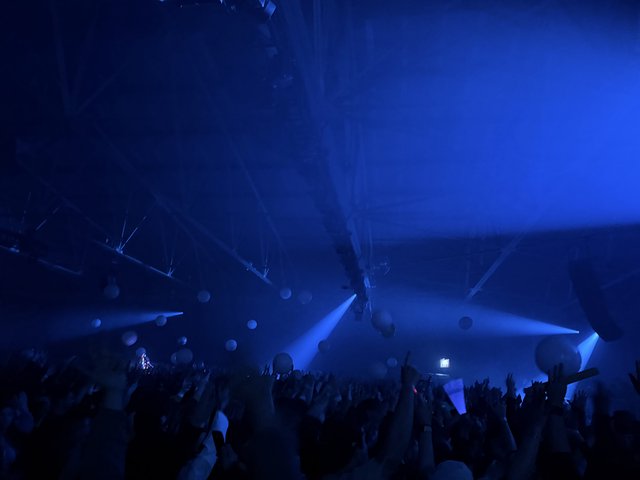 Skrillex Concert: Immersive Blue Light Show with Crowd
