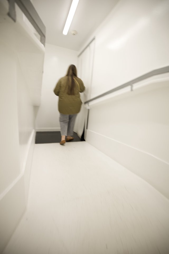 Woman Ascending White Modern Staircase in Minimalist Interior