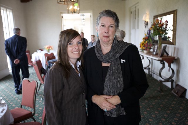 Two Women Share a Moment at Memorial Gathering