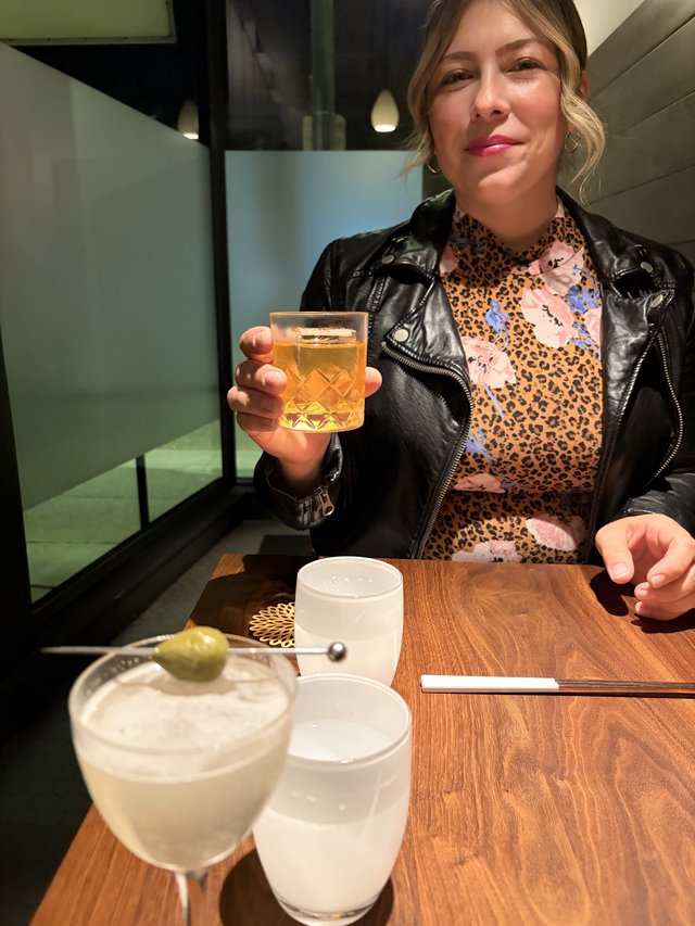 Woman Enjoying Cocktails at Modern Restaurant Bar