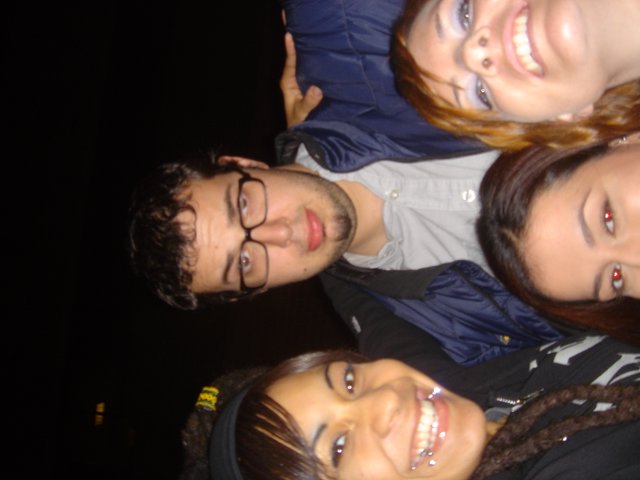 Four Friends Smiling Together on a Dark Night