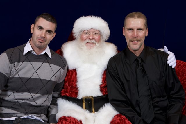 Three Men Posed with Santa Claus for Christmas Party