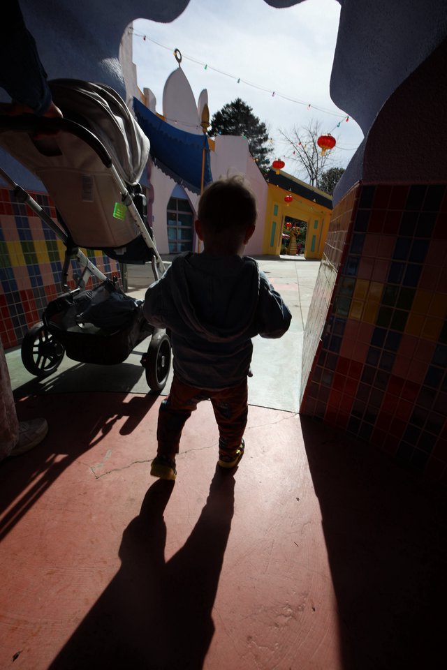 Child Explores Colorful Fantastical Village Square