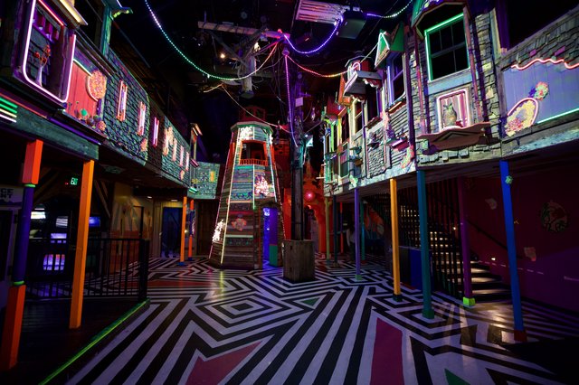 Neon-Lit Interactive Art Installation with Geometric Floor