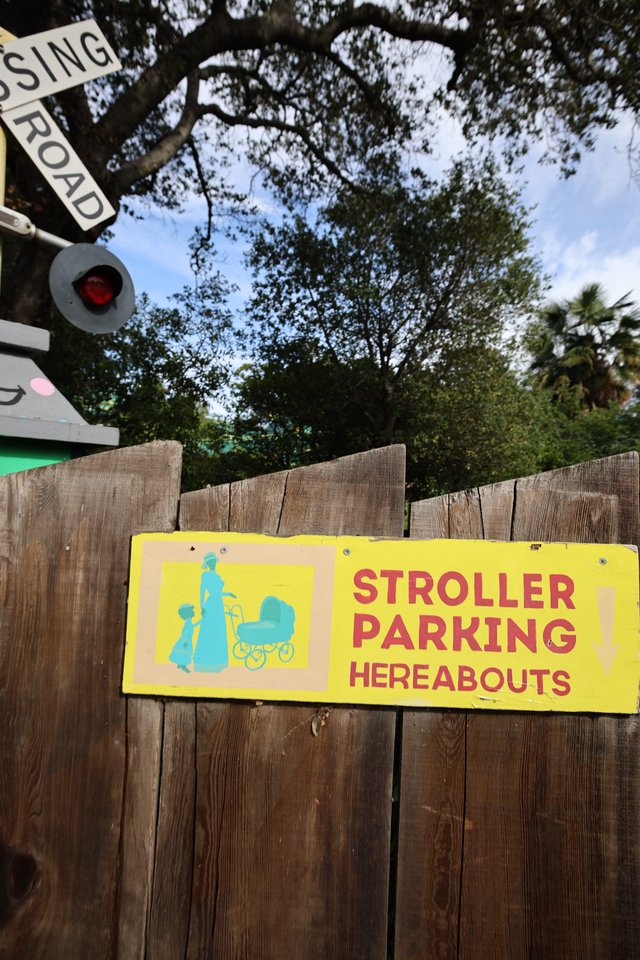 Vintage Stroller Parking Sign at Railroad Crossing