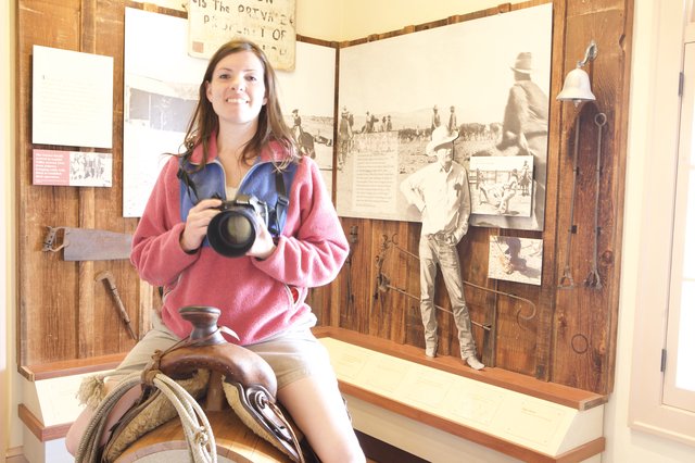 Photographer Poses on Saddle at Western Heritage Museum