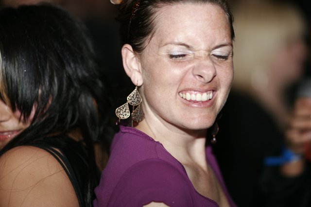 Joyful Woman Laughing at Nighttime Social Event