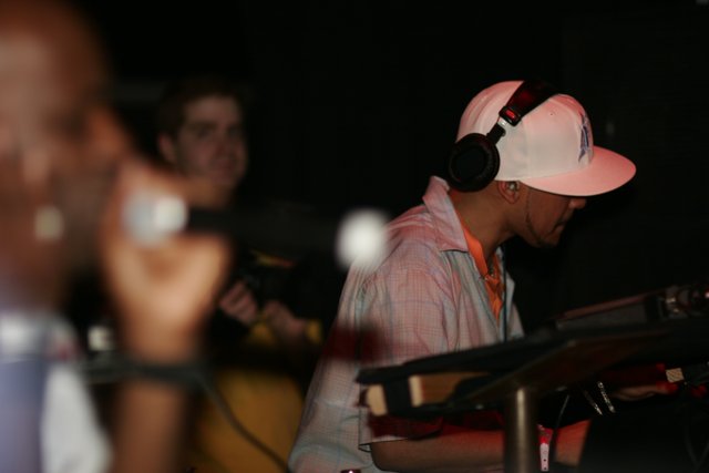 Man in White Hat Rocks Out with Headphones and Mic