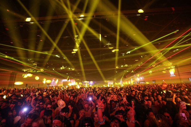 Massive Indoor Crowd Bathed in Laser Light Show