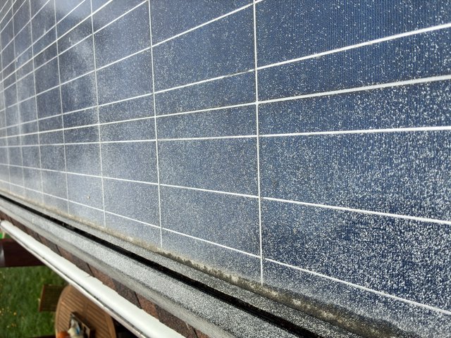 Dew-Covered Solar Panel Array at Dawn