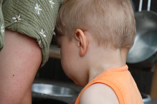 Tender Moment: Child Nestled Against Parent's Shoulder