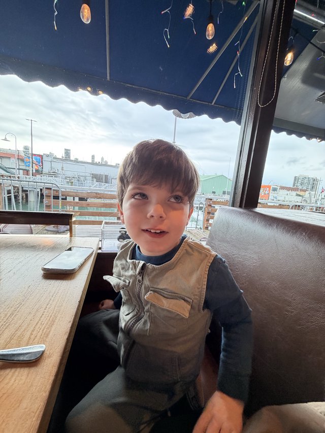 Young Boy at Rooftop Café with City View
