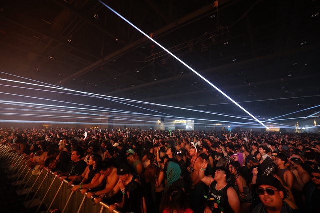 Massive Crowd Surges Under Laser Light Show