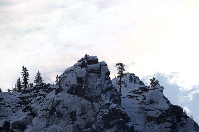 Rocky Summit with Snow-Dusted Evergreens at Dusk